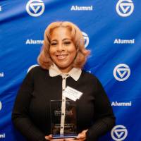 Khadijah Johnson smiles holding her award